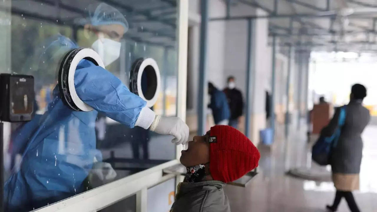 A healthcare worker collects a test swab sample from a child amidst the spread of the coronavirus disease, at a testing centre inside a hospital in New Delhi. (File photo: Reuters)