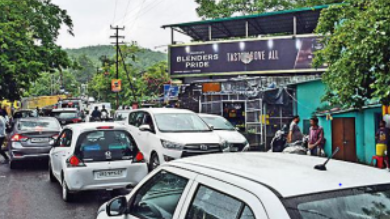 Traffic jam caused by vehicles near a liquor shop on Old Mussoorie road in Dehradun on Sunday