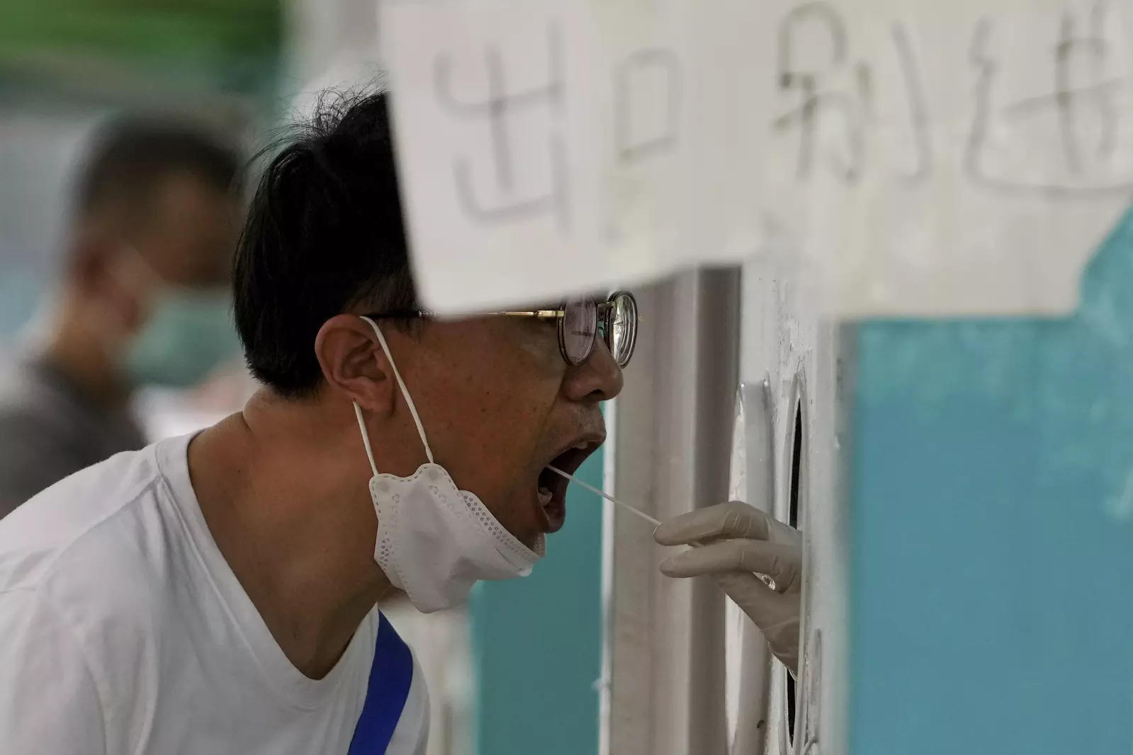 A resident gets his routine throat swabs at a Covid-19 testing site in Beijing 