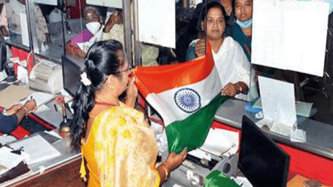People buy national flag at a post office In Madurai