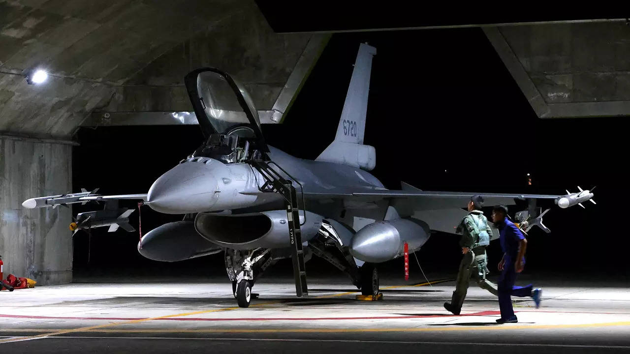 A pilot and Air Force soldier run towards a F-16V fighter jet for an evening take off as part of a combat readiness mission at the airbase in Hualien, Taiwan. (Reuters)