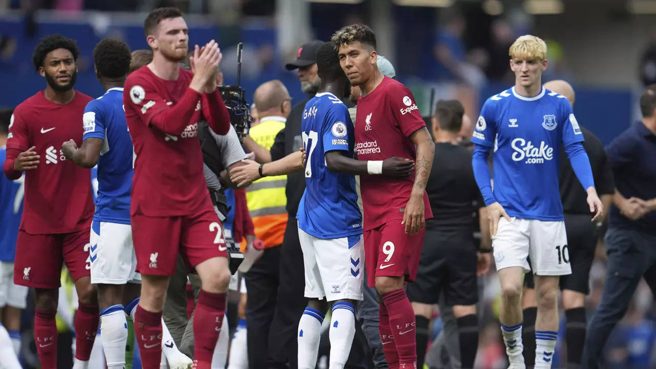 Liverpool's Roberto Firmino, right, hugs Everton's Idrissa Gueye at the end of the match at Goodison Park. (AP Photo)