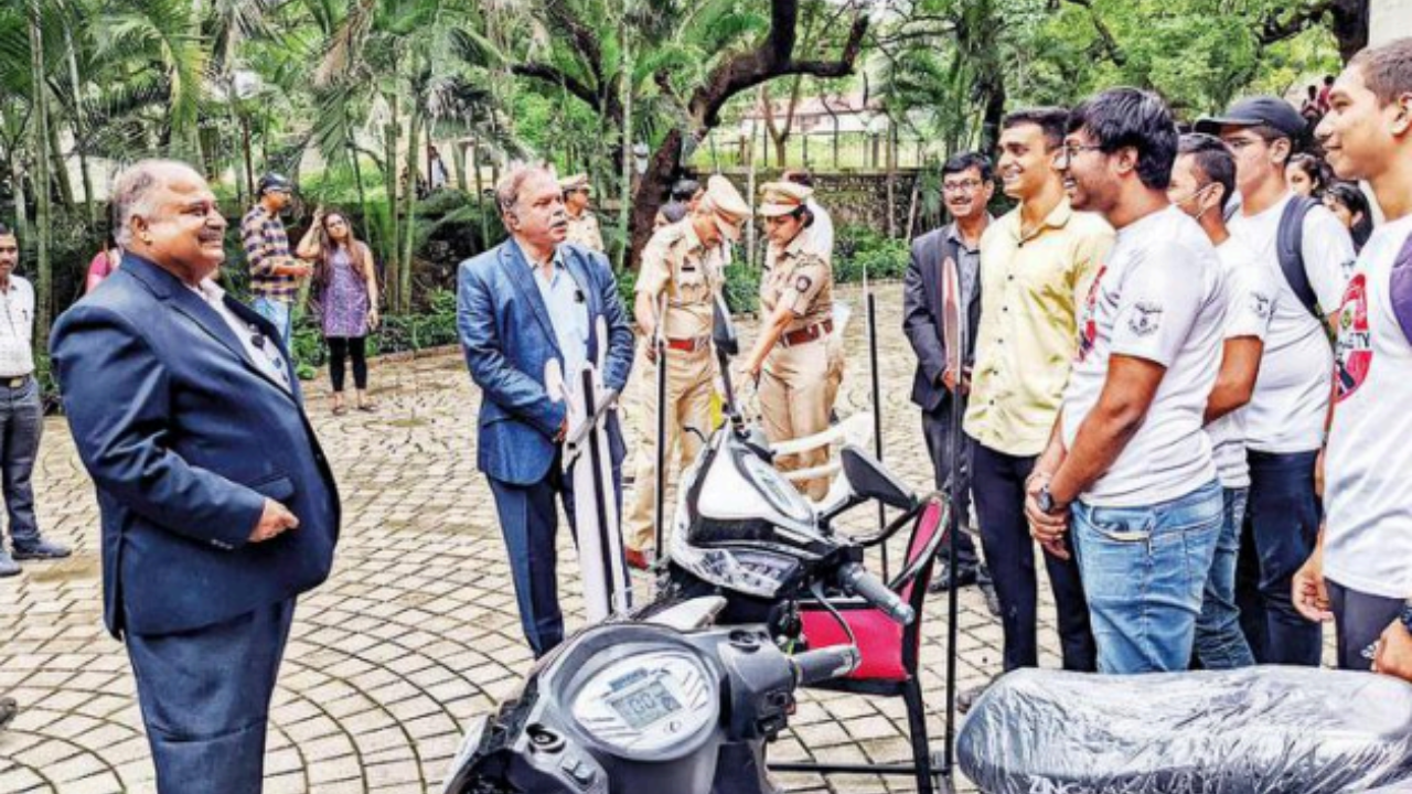 Fergusson College principal Ravindrasinh Pardeshi (left) and RTO Ajit Shinde interact with students on road safety during a special drive to issue learner’s licences at the college on Wednesday