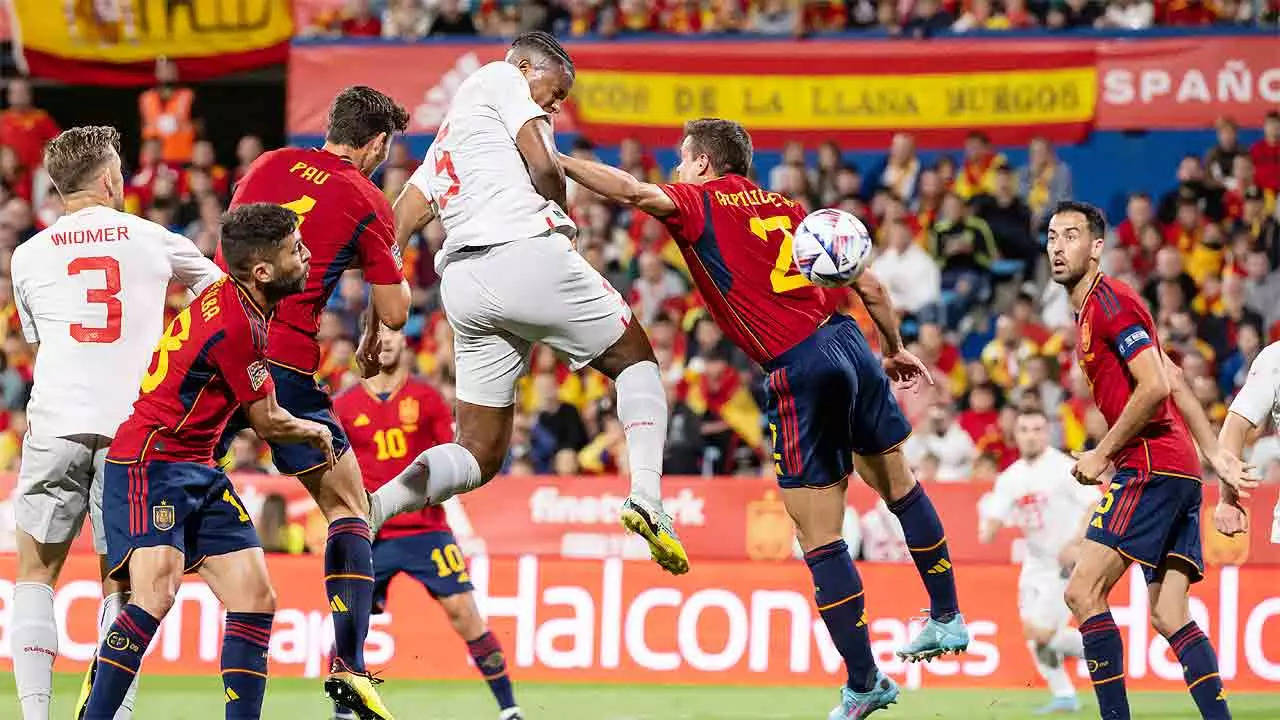 Switzerland's Manuel Akanji, center left, scores with a header against Spain. (AP Photo)