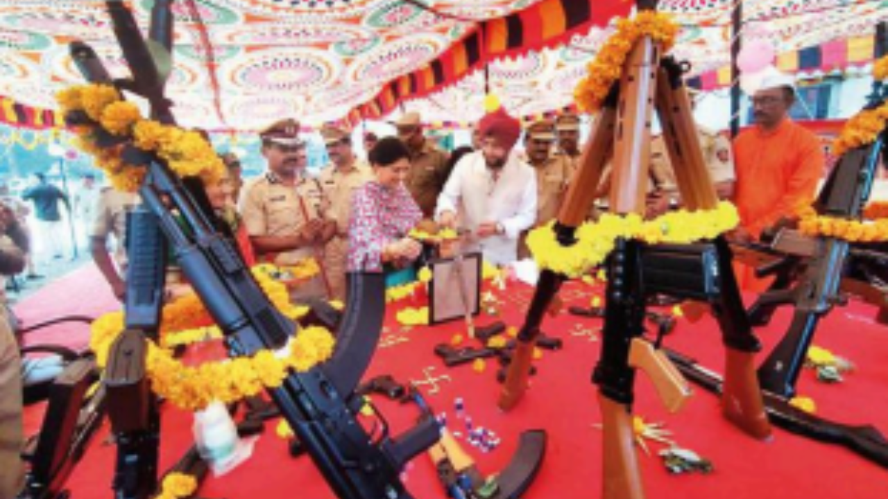 Police personnel perform Shastra Puja of their weapons in Thane on Wednesday