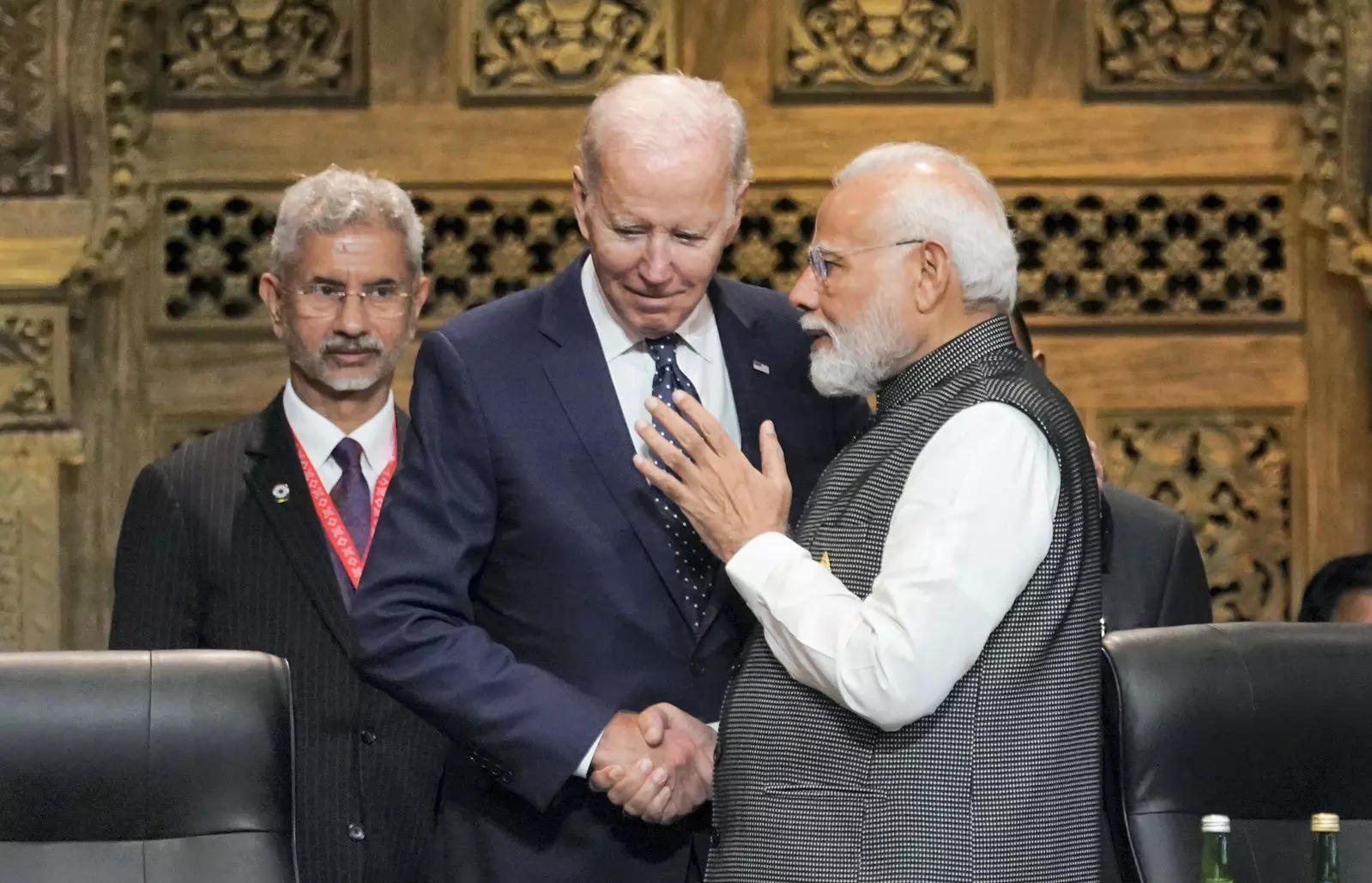 Indian Prime Minister Narendra Modi shakes hands with US President Joe Biden as India's Foreign Minister Subrahmanyam Jaishankar watches during the first working session of the G20 leaders' summit in Nusa Dua, Indonesia. (AP/PTI Photo)