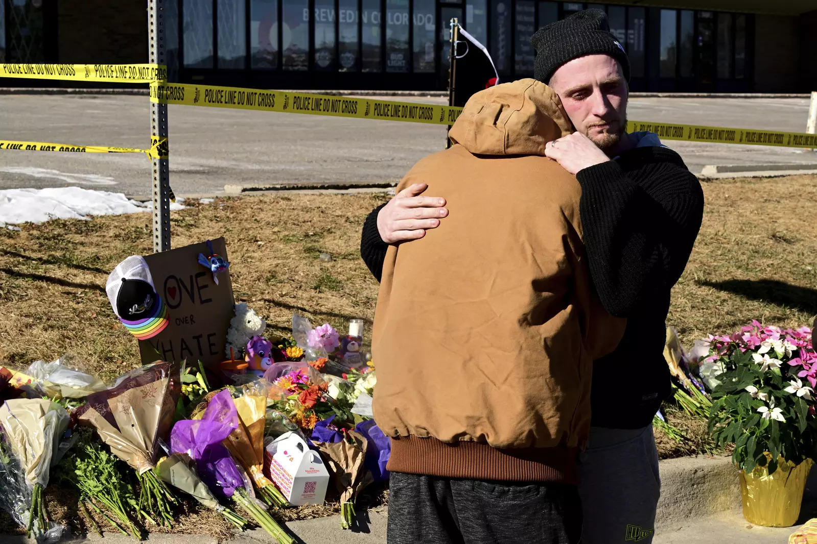 A man comforts another at a makeshift memorial near Club Q, Sunday in Colorado Springs. (File photo: AP)