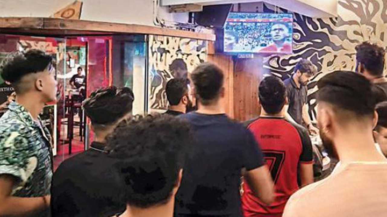 Patrons revelling during a football match at a city eatery 