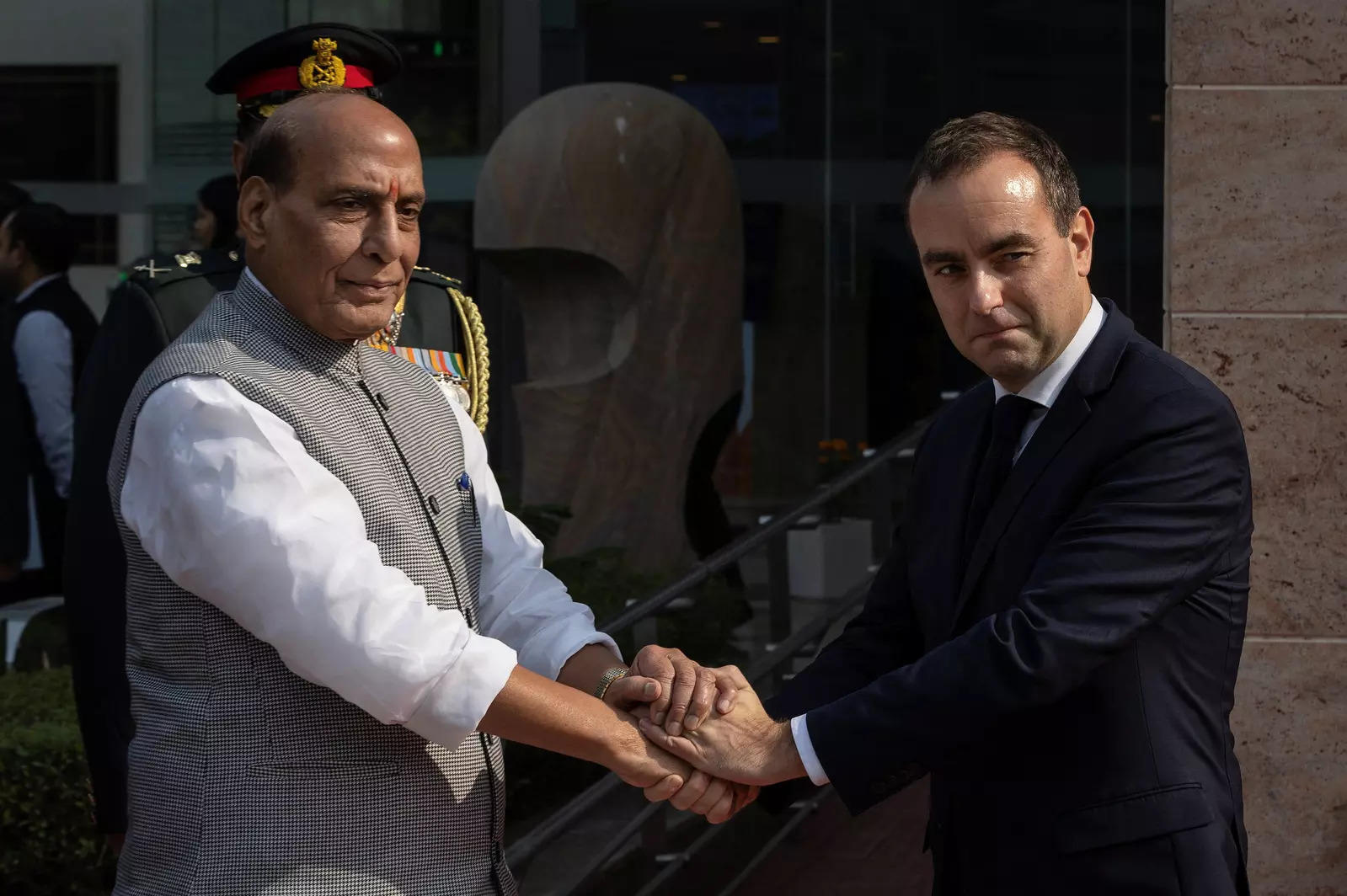 French defence minister Sebastien Lecornu (right) shakes hands with his Indian counterpart Rajnath Singh during a ceremonial reception in New Delhi.