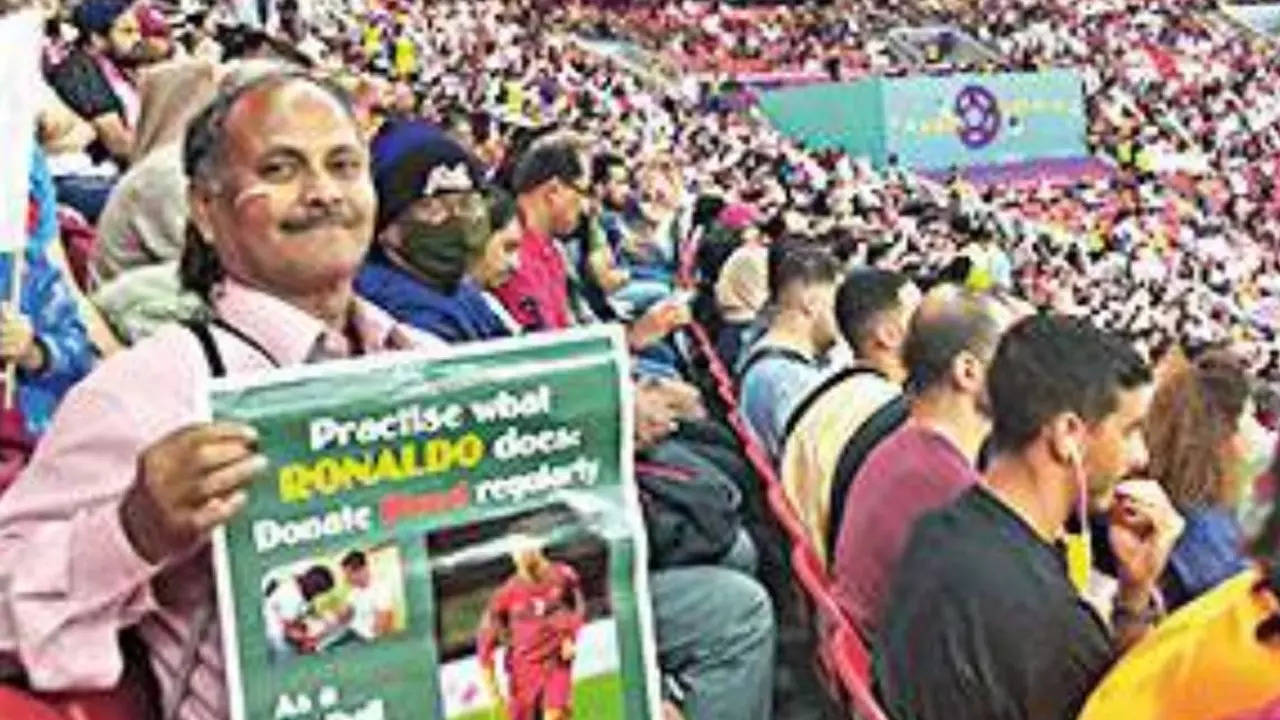 Ashok Biswas displays his poster at the Al Bayt stadium on Tuesday