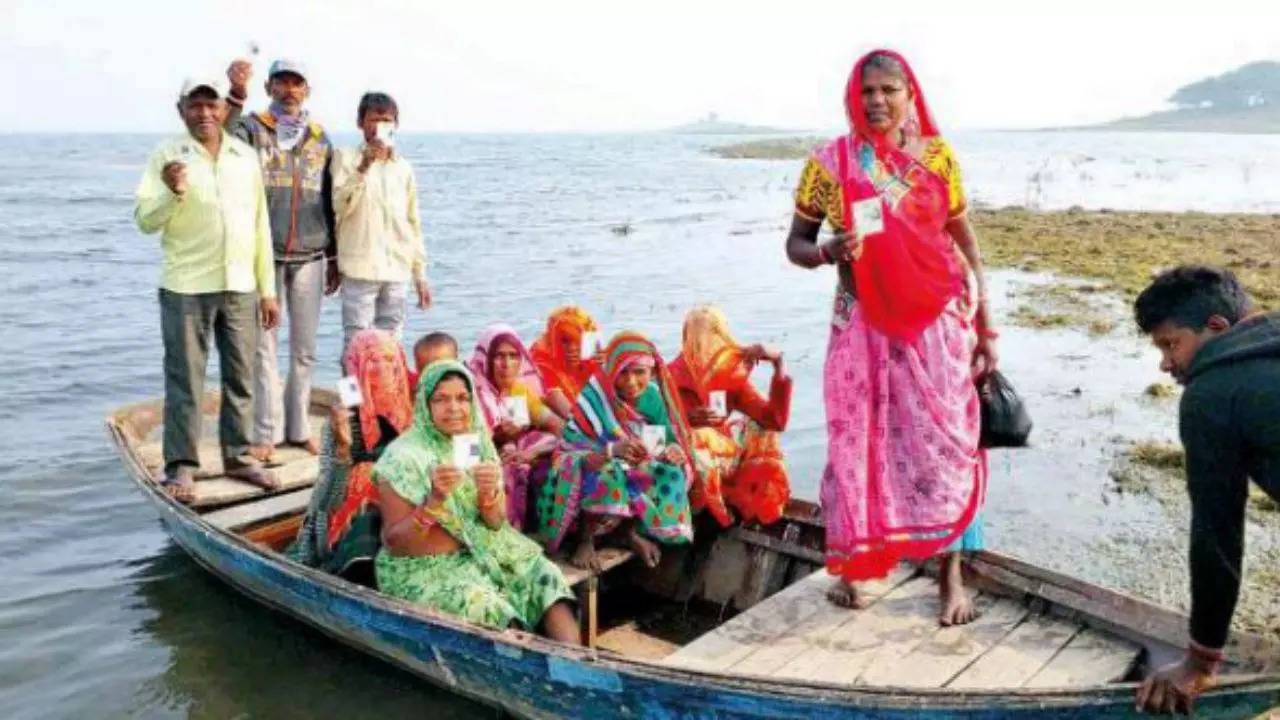 Voters of the Simlet island in the catchment area of the Panam dam in Panchmahal used a boat to go to vote at polling booth in Mehlan village. The island falls under Shehra assembly constituency