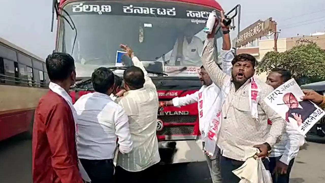 People from local outfits spray black paint on a Karnataka bus in Solapur on Wednesday.