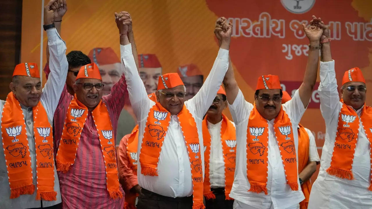 Bhupendra Patel (3rdL) with Gujarat BJP president CR Patil (2nd R) and other leaders celebrating the party's win in Gandhinagar. (AP photo)