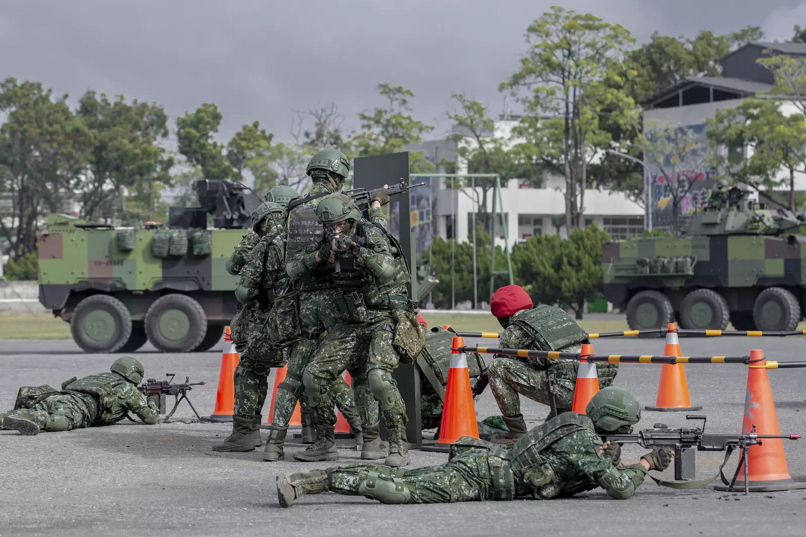 In this photo released by the Taiwan Presidential Office, soldiers take part in a drill during a visit by Taiwan's President Tsai Ing-wen, at a military base in Chiayi in southwestern Taiwan.
