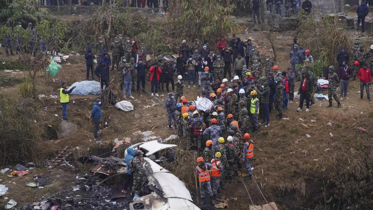 Rescuers scour the crash site in the wreckage of a passenger plane in Pokhara, Nepal, Monday. (PTI photo)