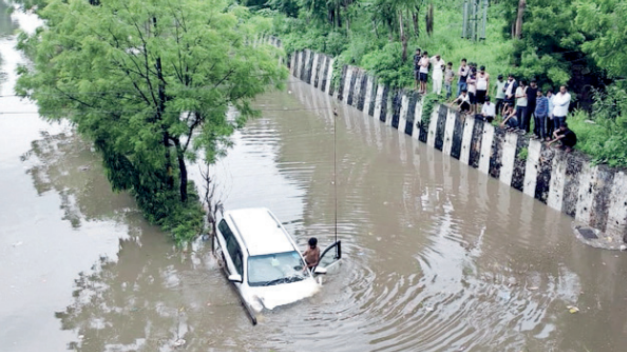 File pic of minister Murali Lal Meena’s daughter’s car that got stuck below the waterlogged Nandpuri underpass due to heavy rainfall