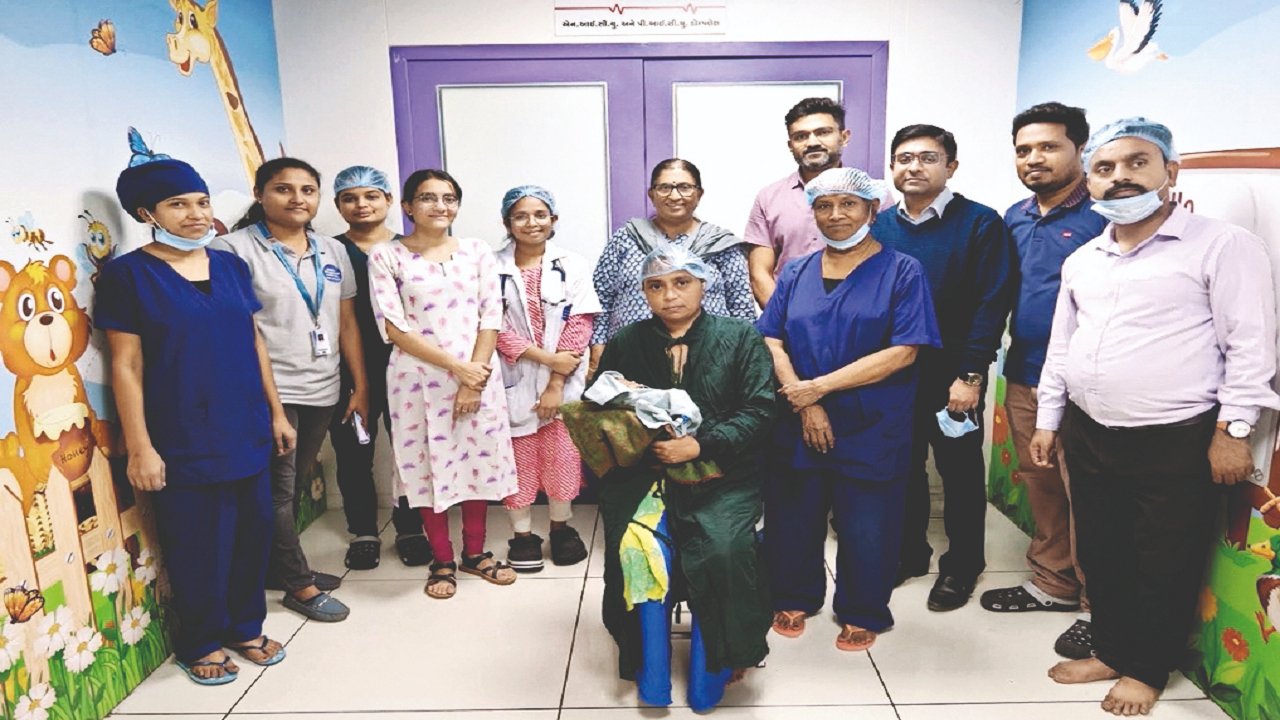 The medical team with the surviving infant after the operation