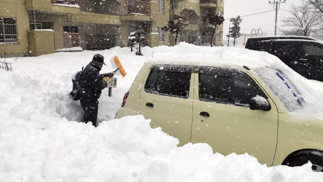Cars stranded, flights cancelled as heavy snow blankets Japan