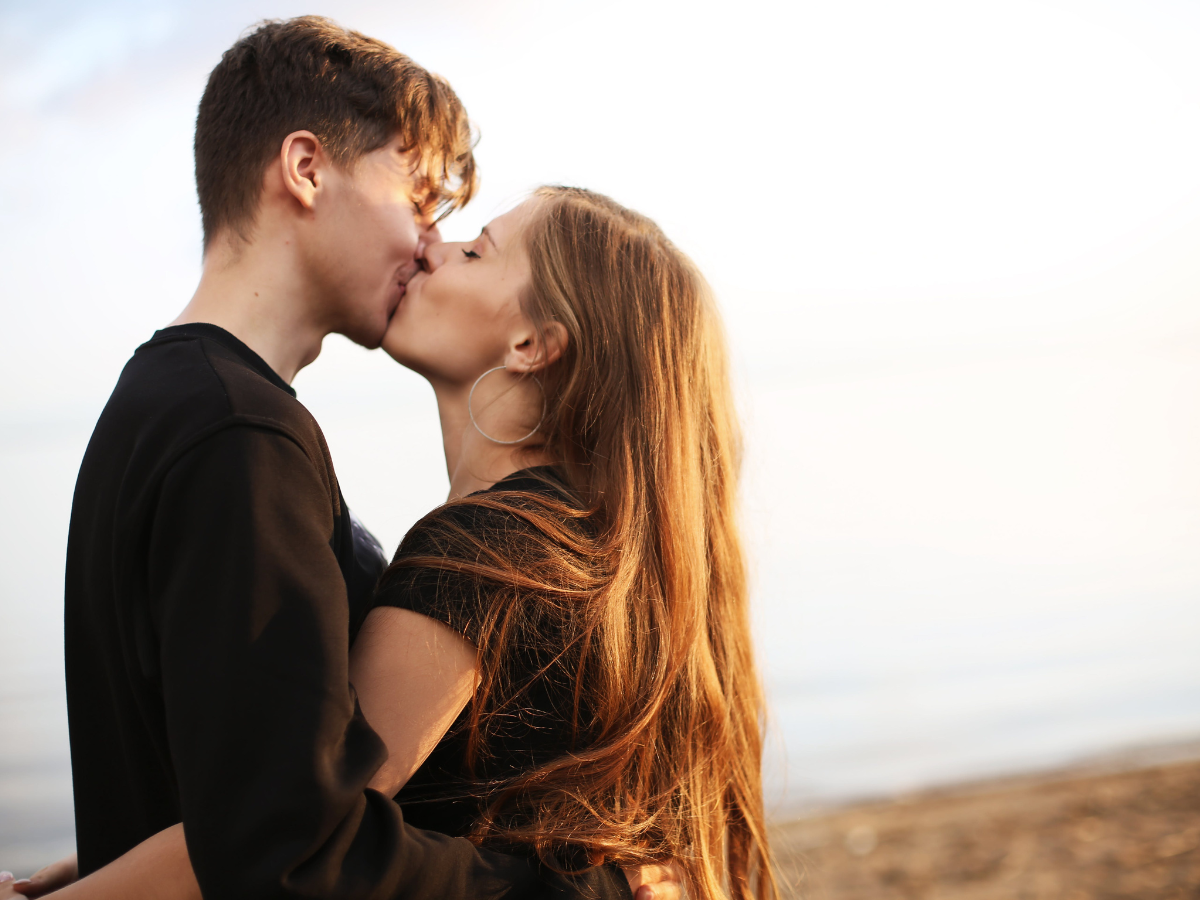 Girl Crying Next to a Kissing Couple