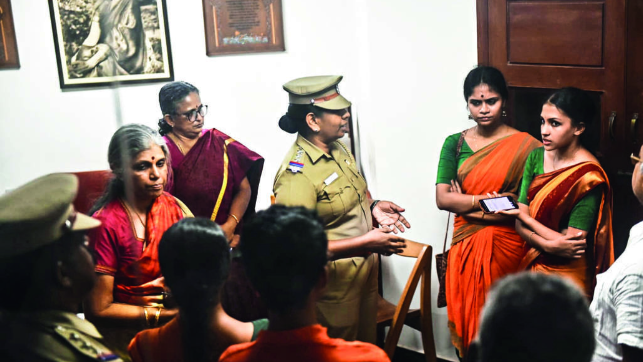A police officer tries to pacify protesting students in the presence of Kalakshetra Foundation director Revathi Ramachandran (2nd from left)
