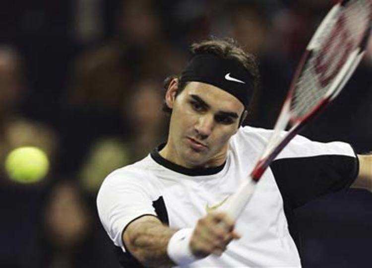 World's number one player, Switzerland's Roger Federer prepares to serve a  ball against Argentina's David Nalbandian (unseen) during the opening match  for the Shanghai Tennis Masters Cup held at the Qi Zhong