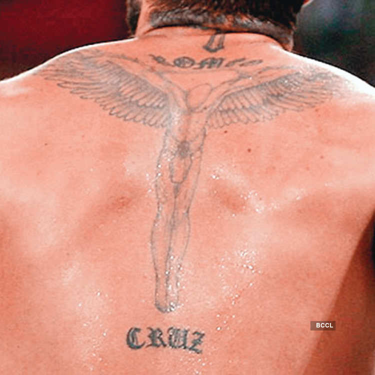 Third baby Cruz's name added beneath the feet of the angel on his back