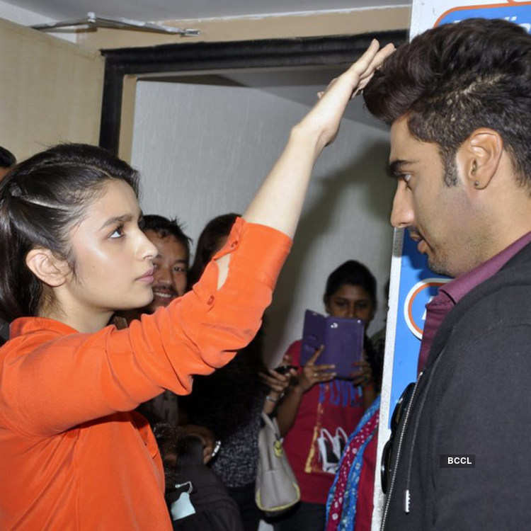 Alia Bhatt helps Arjun Kapoor with his hairstyle during the promotion of  movie 2 States, held at Radio City, on March 27,