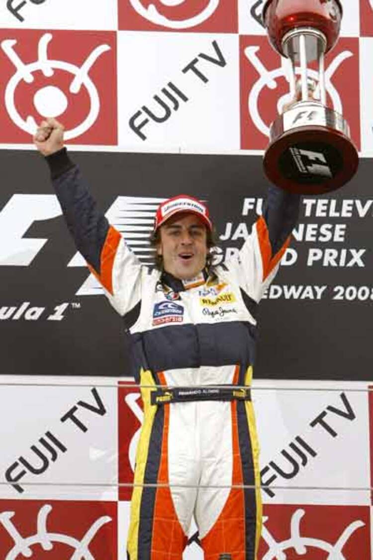 Renault Formula One driver Fernando Alonso celebrates after