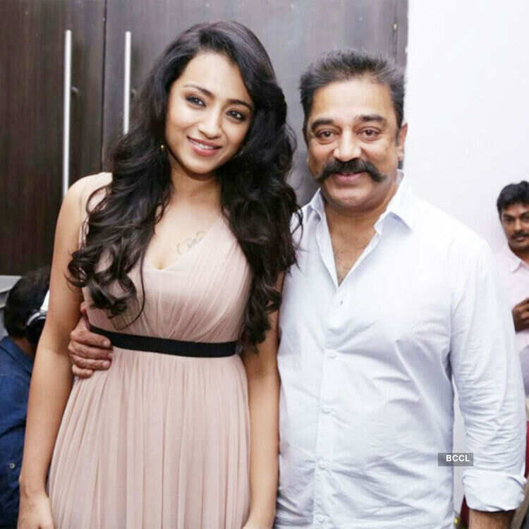 Trisha and Kamal Haasan pose for a photo during the audio launch of Tamil  movie Thoongavanam