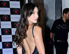 Nora Fatehi stuns in a black satin thigh-high slit dress at a film's wrap-up party