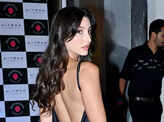 Nora Fatehi stuns in a black satin thigh-high slit dress at a film's wrap-up party