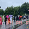 People brave rains as they queue up to enter the White House for PM Modi's ceremonial welcome.