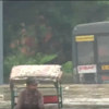 A rickshaw-puller pedals through chest-deep water in the flooded area near Red Fort.