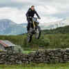 Riding a motorcycle off a cliff in the mountains of Norway