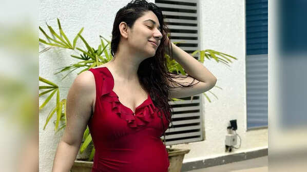 Flaunting her baby bump in a swimsuit