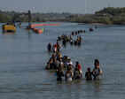 Asylum-seekers traverse Rio Grande into the US