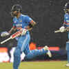 Virat Kohli, left, and KL Rahul run for cover as it rains during the Asia Cup match between India and Pakistan in Colombo