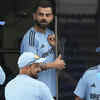 Virat Kohli speaks with teammates as they stand outside their team dressing room in Colombo, Sri Lanka on Monday.