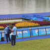 India's #rowing coach Ismail Baig standing close to the finish line, anxiously waiting for the start of India's first medal race