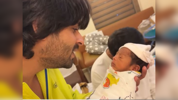 Shoaib holding Ruhaan for the first time