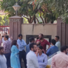 People come out of offices in Noida 