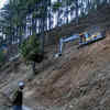 An earth remover making way for another rescue way above the tunnel where 40 workers are trapped.