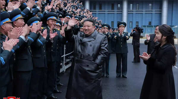 Workers enthusiastically cheered Kim and Ju Ae