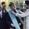 Macron stands out in sea green scarf