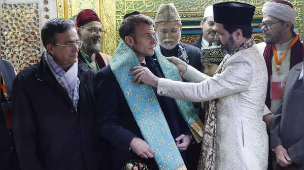 Macron stands out in sea green scarf