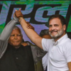 Rahul and Lalu stand together, hand-in-hand.