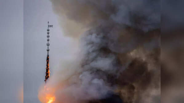 Spire collapses as fire engulfs stock building
