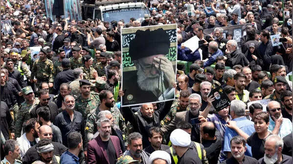 Mourners carry photos during funeral procession