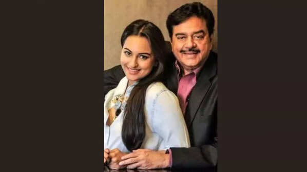 Shatrugan Sinha and Sonakshi hugging to the side, hands wrapped together