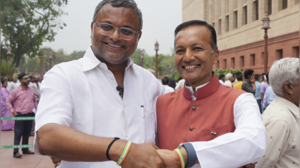 Karti Chidambaram and Naveen Jindal share firm handshake